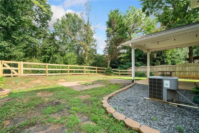 a view of a house with a backyard