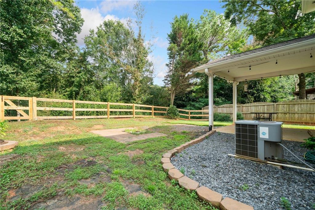 151 Nacoochee Way Canton, GA 30114 - Photo 34 of 36 a view of a house with a backyard