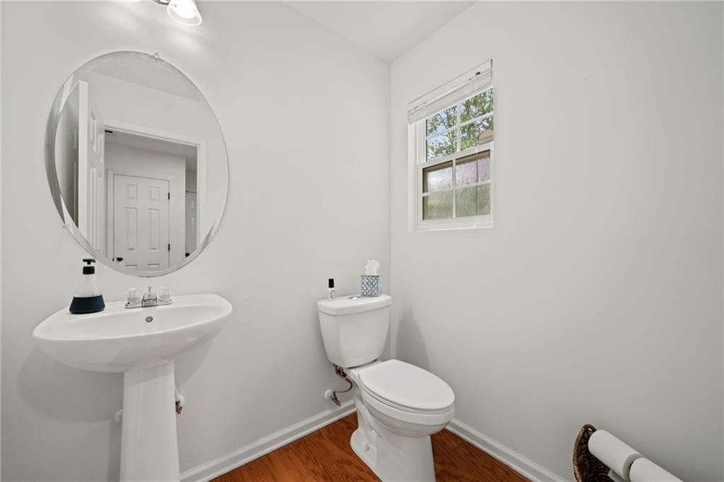 151 Nacoochee Way Canton, GA 30114 - Photo 10 of 36 a bathroom with a toilet a sink and mirror