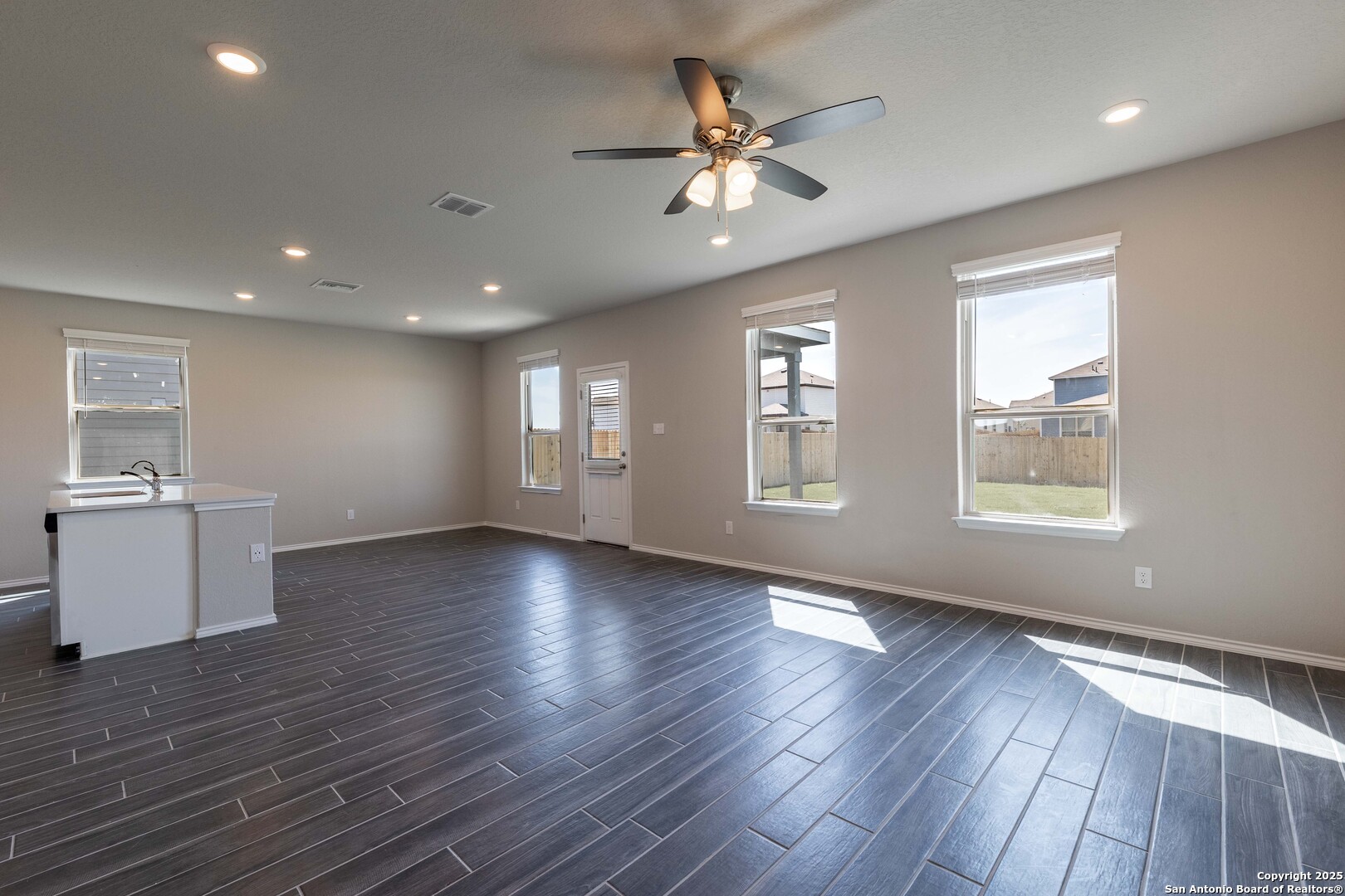 4211 Brigade Bend Converse, TX 78109 - Photo 11 of 30 a view of an empty room with a window and wooden floor