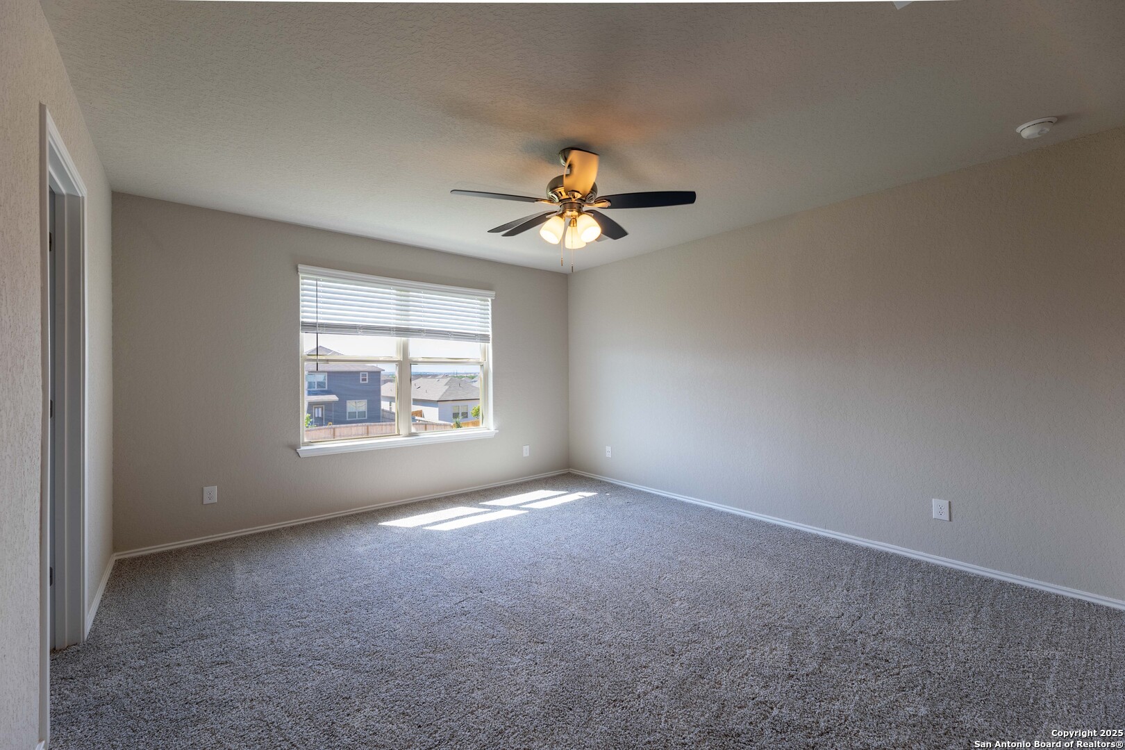 4211 Brigade Bend Converse, TX 78109 - Photo 14 of 30 a view of a room with a ceiling fan and a window