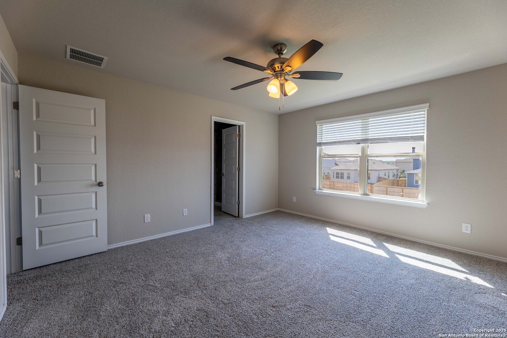 4211 Brigade Bend Converse, TX 78109 - Photo 15 of 30 an empty room with windows and fan