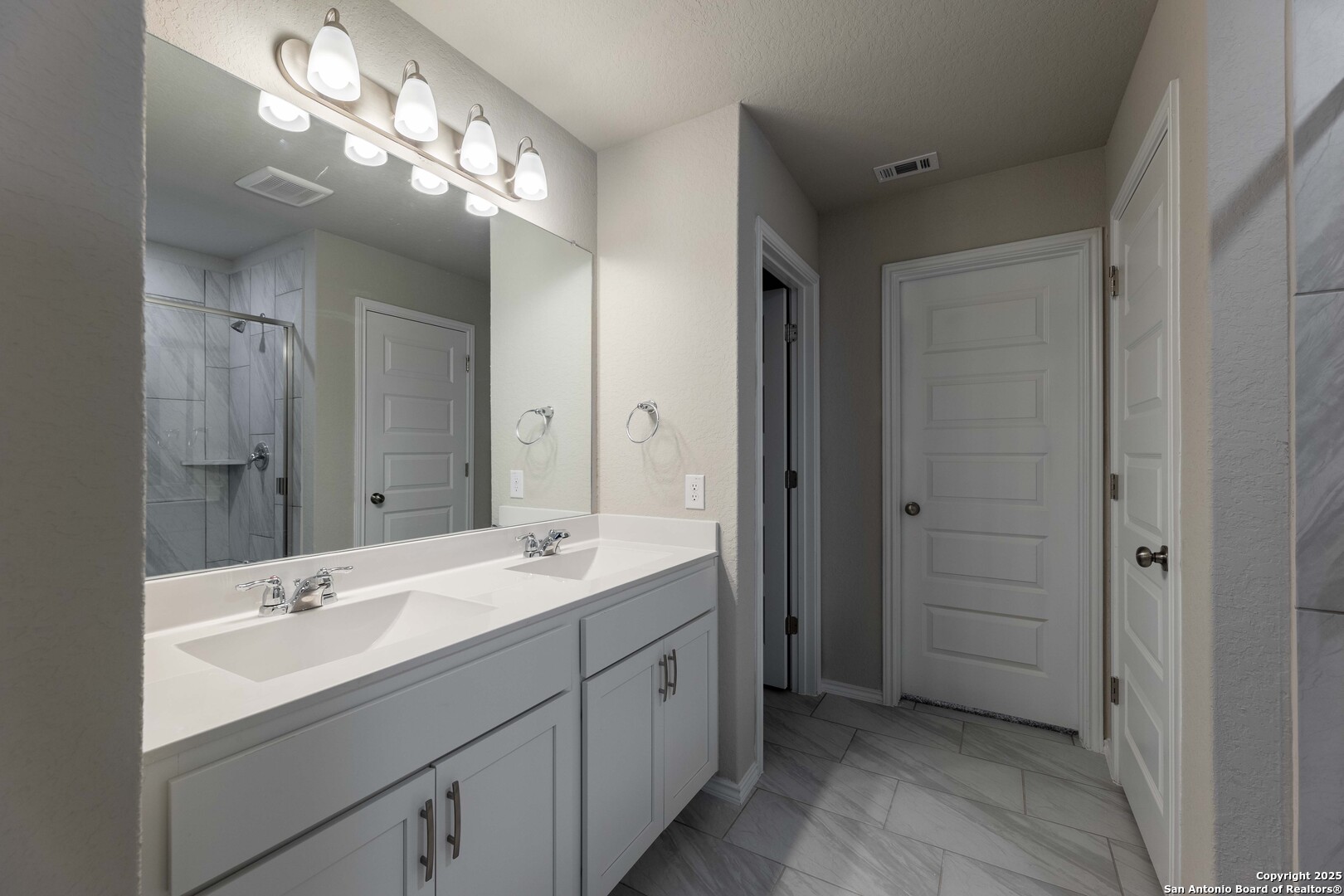 4211 Brigade Bend Converse, TX 78109 - Photo 18 of 30 a spacious bathroom with a double vanity sink a large mirror and a shower
