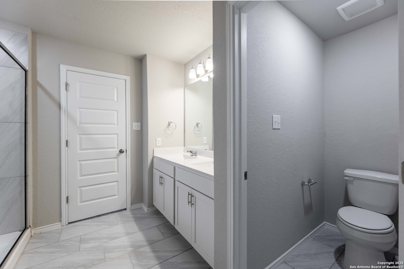 4211 Brigade Bend Converse, TX 78109 - Photo 19 of 30 a bathroom with a granite countertop toilet a sink and a mirror