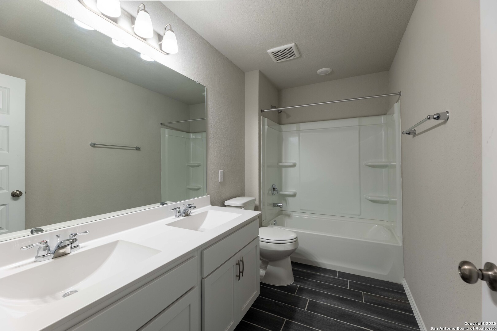 4211 Brigade Bend Converse, TX 78109 - Photo 26 of 30 a bathroom with a bathtub shower sink mirror and toilet