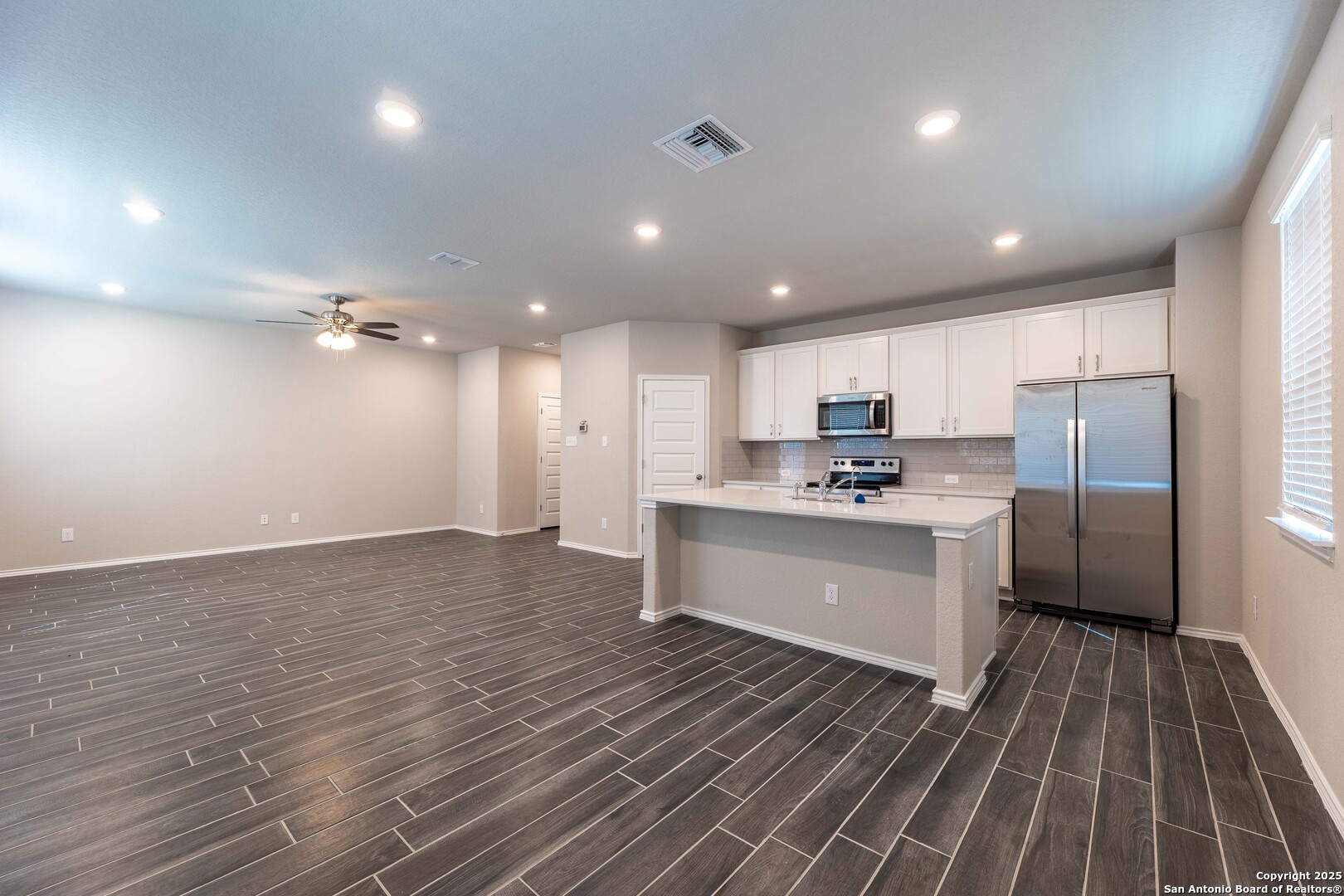 4211 Brigade Bend Converse, TX 78109 - Photo 7 of 30 a large kitchen with kitchen island a sink stainless steel appliances and cabinets