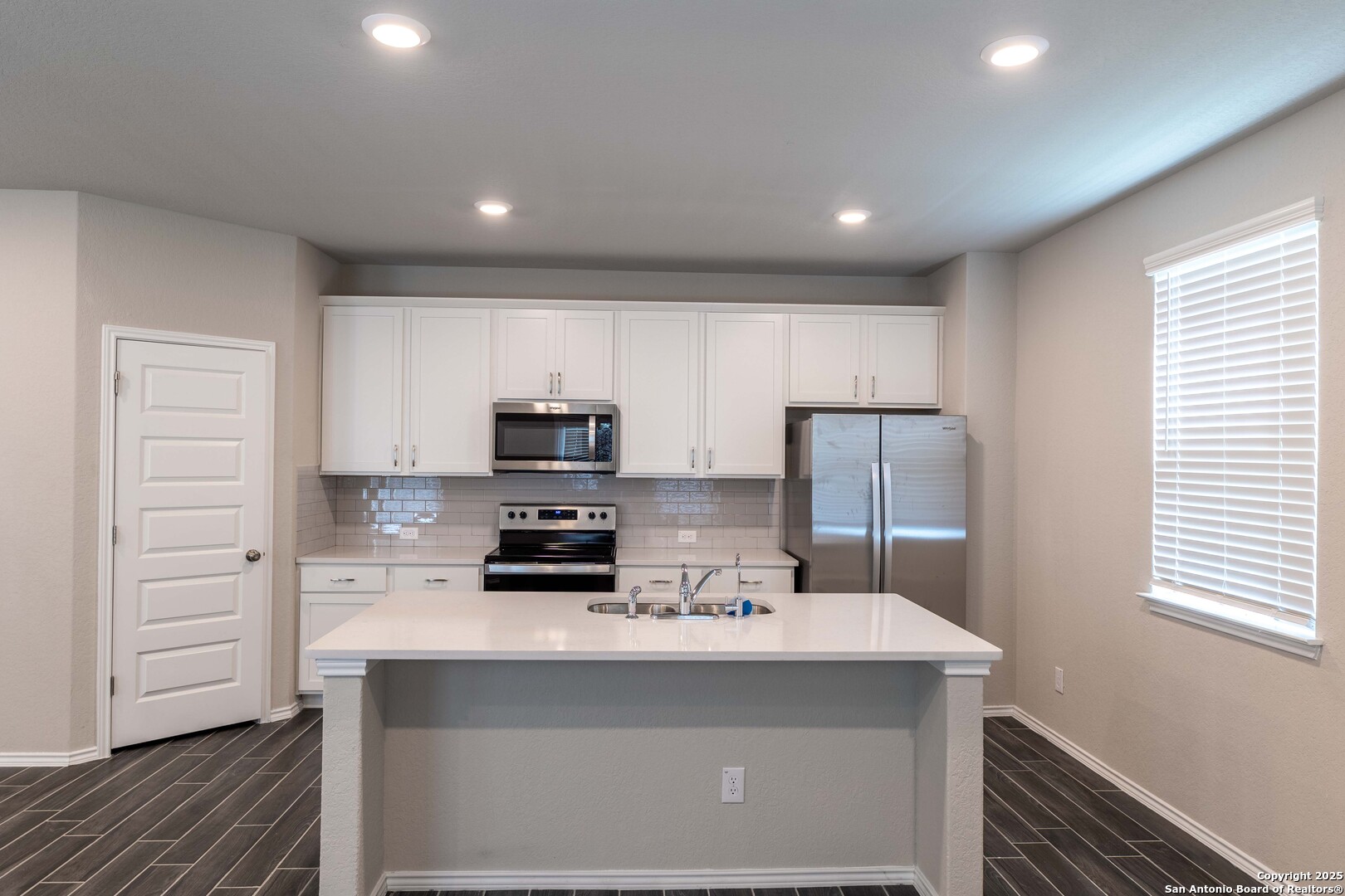 4211 Brigade Bend Converse, TX 78109 - Photo 8 of 30 a kitchen with kitchen island a sink stainless steel appliances and cabinets