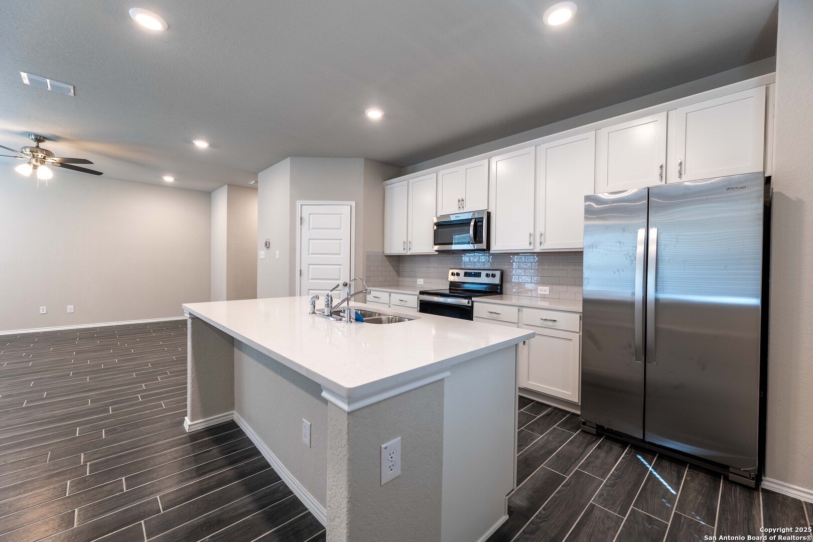 4211 Brigade Bend Converse, TX 78109 - Photo 9 of 30 a kitchen with kitchen island a sink stainless steel appliances and cabinets