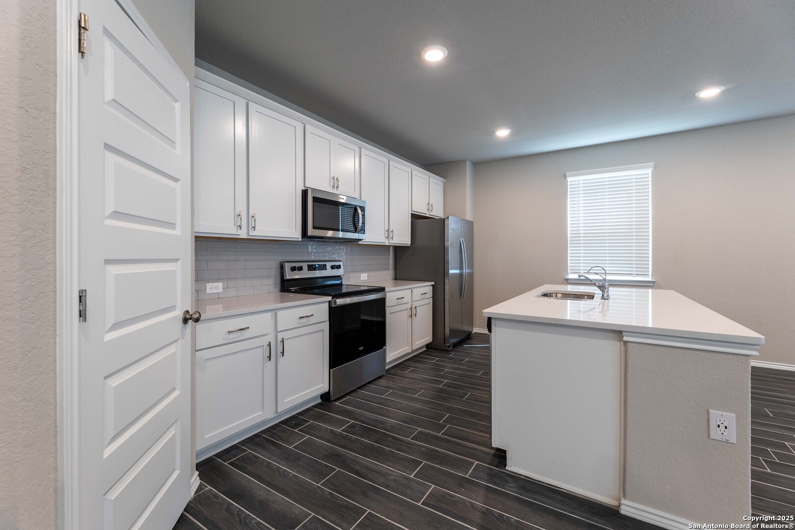 4211 Brigade Bend Converse, TX 78109 - Photo 10 of 30 a kitchen with sink a microwave and cabinets
