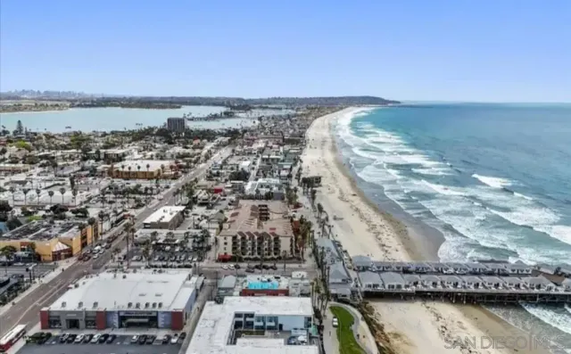 an aerial view of a house with a ocean view