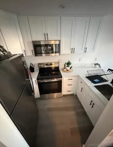 a kitchen with stainless steel appliances a stove a microwave and cabinets