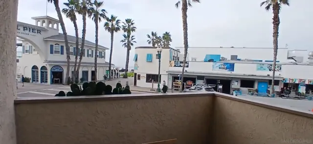 a view of a lake with boats and palm trees