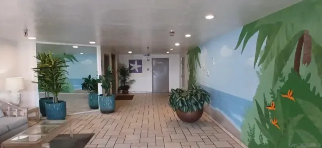 a lobby with furniture and potted plant