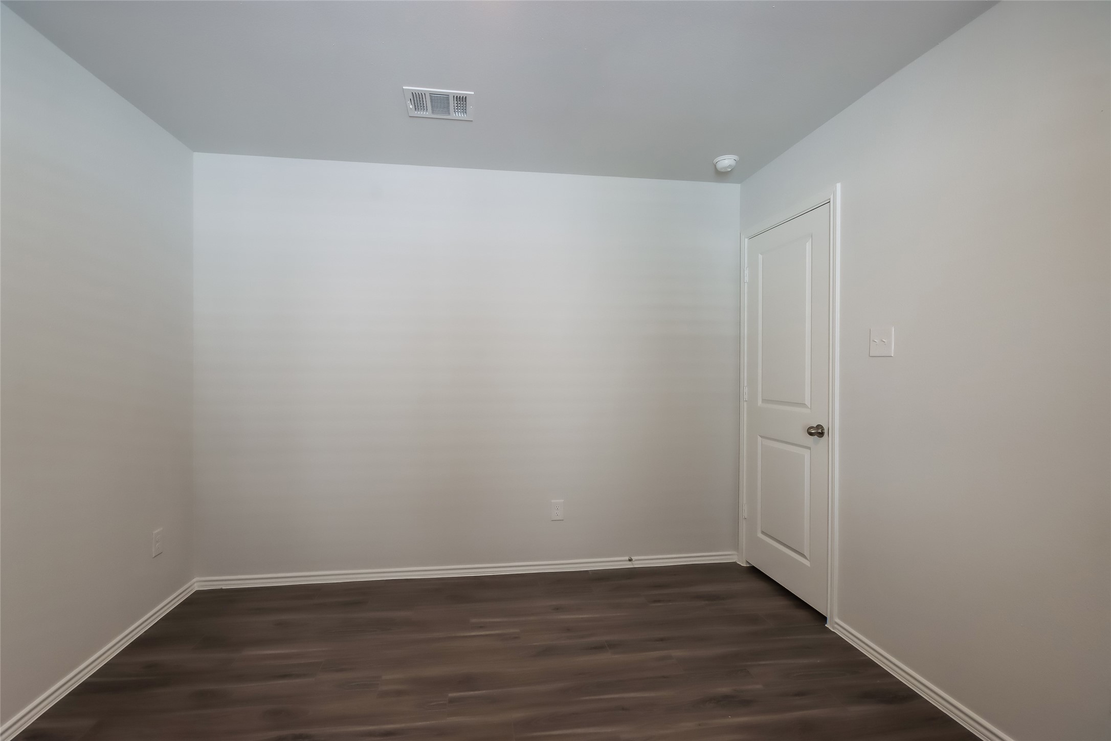 13524 White Ibis Street Splendora, TX 77372 - Photo 12 of 17 a view of an empty room with wooden floor