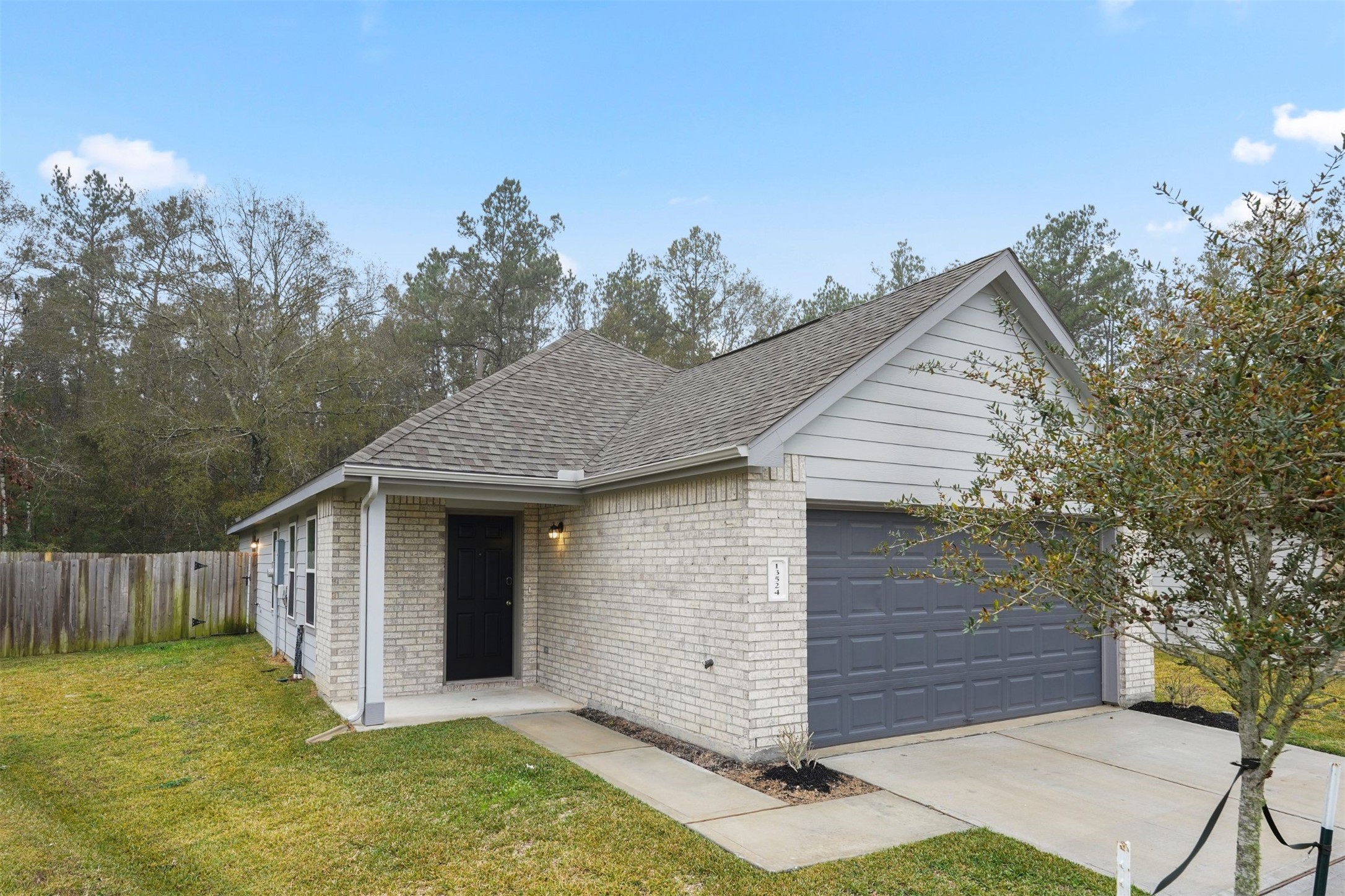 13524 White Ibis Street Splendora, TX 77372 - Photo 3 of 17 a view of a house with a yard
