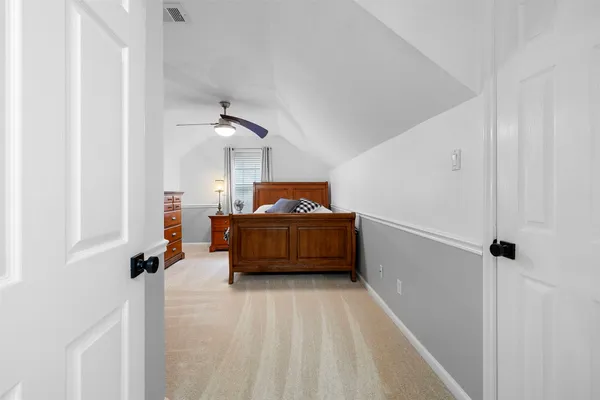a view of a bedroom with furniture and closet