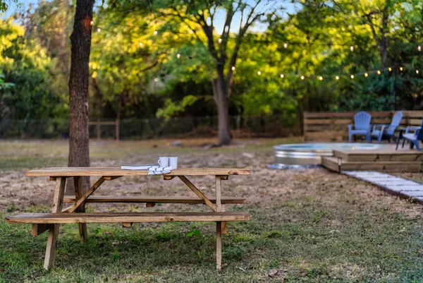 a backyard of a house with table and chairs