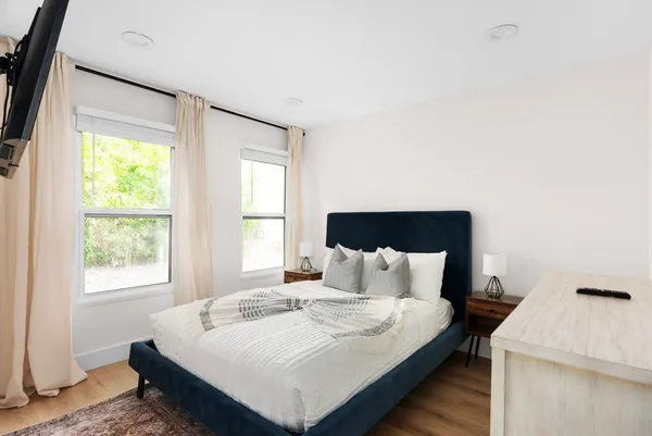 a bedroom with a bed and a window