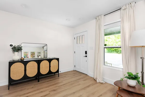a view of a room with wooden floor and windows
