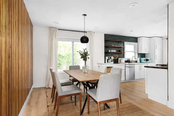 a dining room with furniture and window