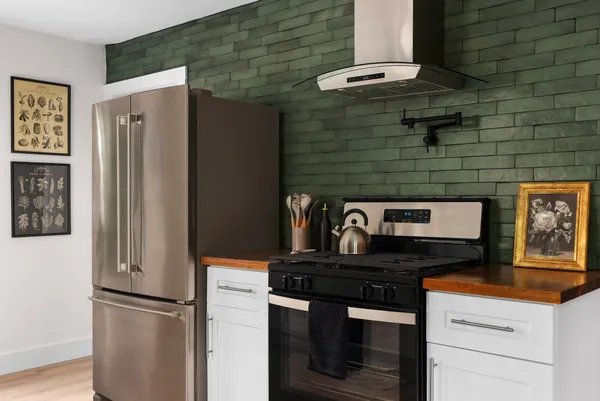 a kitchen with stainless steel appliances granite countertop cabinets and a refrigerator