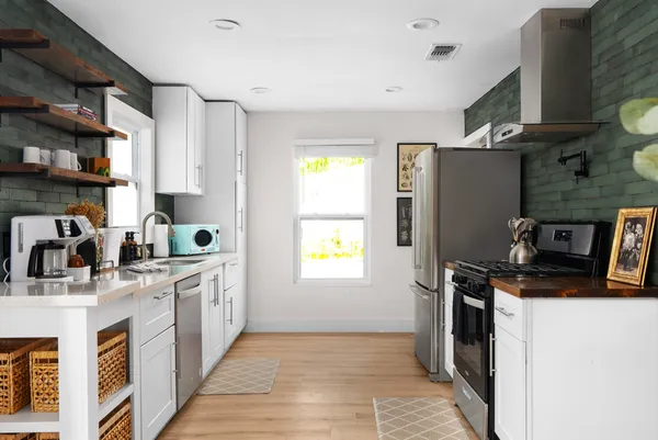 a kitchen with stainless steel appliances granite countertop a sink stove and refrigerator