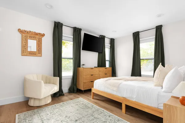 a bedroom with a bed and large window