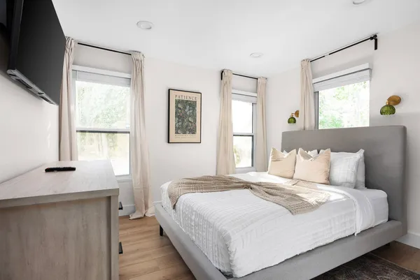 a bedroom with a bed and a window