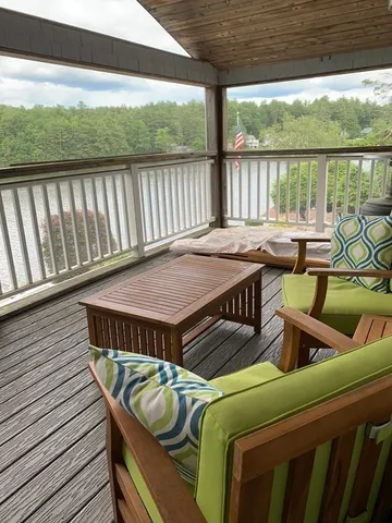 a roof deck with a table and chairs