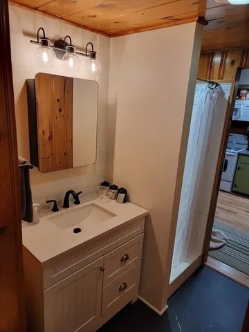 a bathroom with a sink and mirror