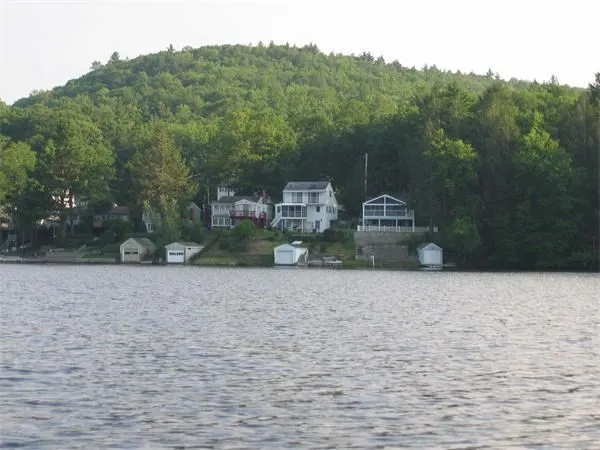 a pathway of a house next to a yard