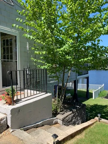 a view of house with backyard outdoor seating and green space