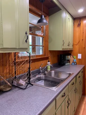 a kitchen with a sink and a stove top oven