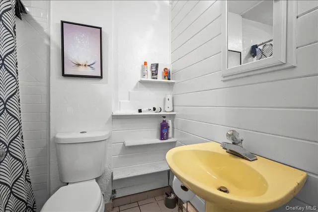 a bathroom with a sink mirror vanity and toilet