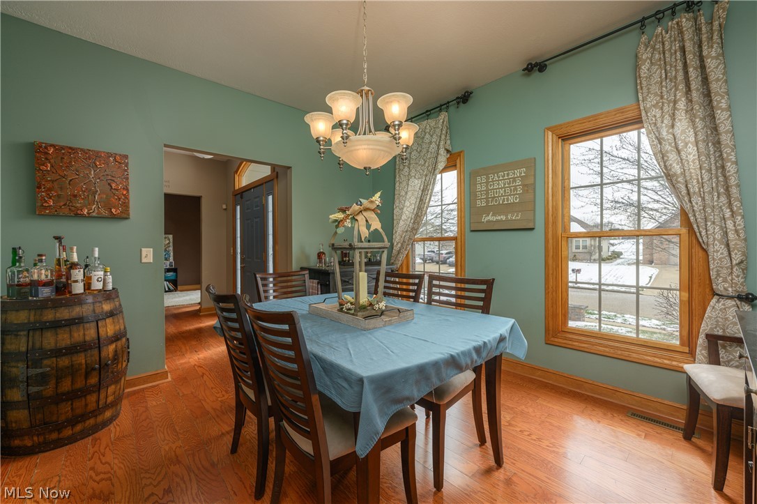 806 Forrest Ridge Drive Dover, OH 44622 - Photo 10 of 36 Dining room with wood finished floors and hanging lights