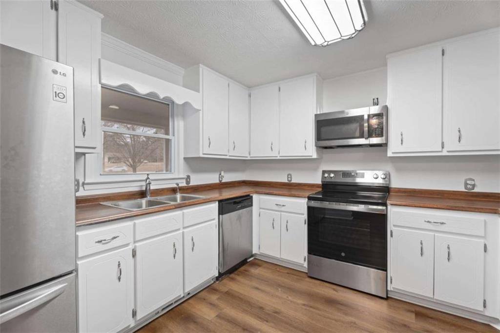 2284 Alcovy Station Road Covington, GA 30014 - Photo 12 of 45 a kitchen with appliances cabinets and a sink