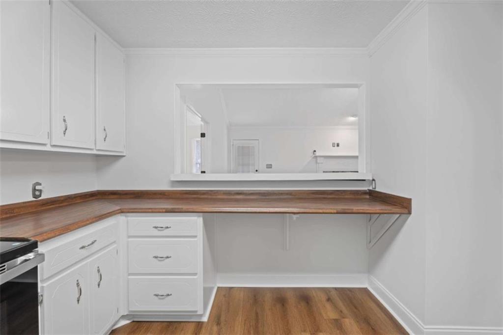 2284 Alcovy Station Road Covington, GA 30014 - Photo 13 of 45 a view of cabinets and wooden floor