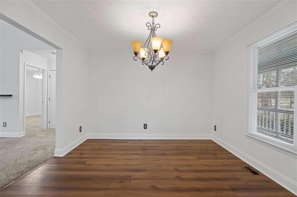 2284 Alcovy Station Road Covington, GA 30014 - Photo 15 of 45 wooden floor in an empty room with a window