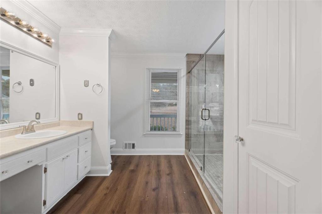 2284 Alcovy Station Road Covington, GA 30014 - Photo 25 of 45 a bathroom with a double vanity sink and mirror