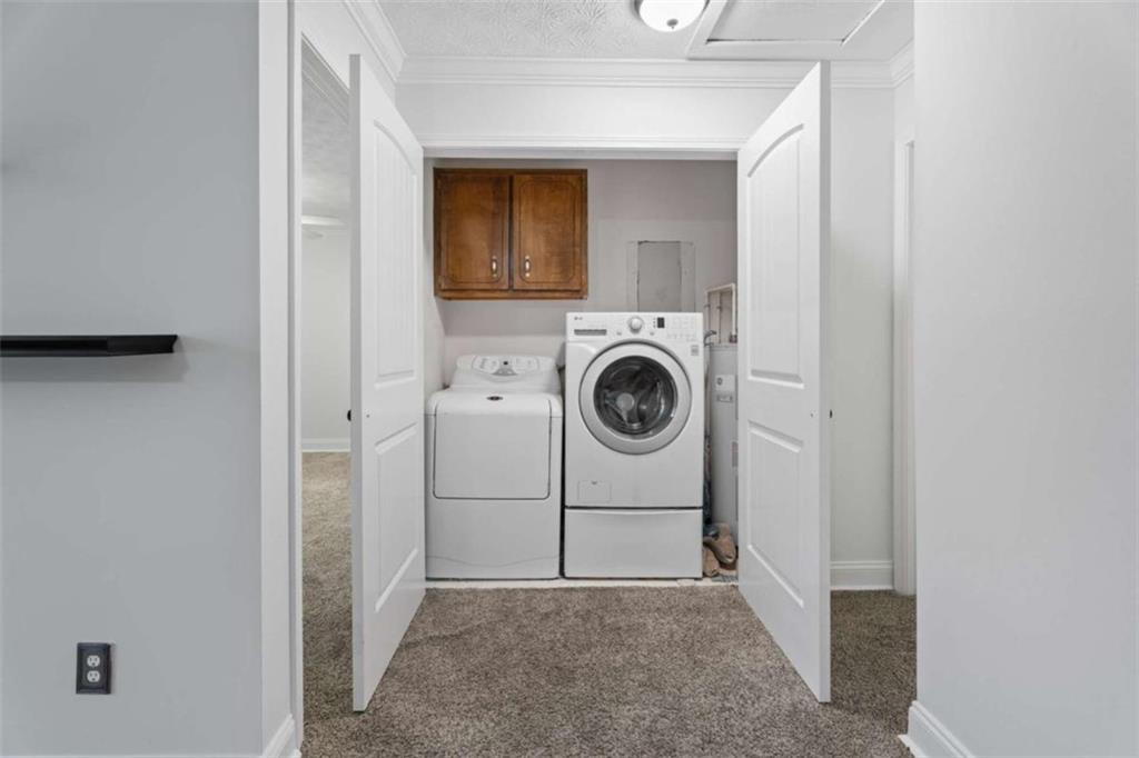2284 Alcovy Station Road Covington, GA 30014 - Photo 29 of 45 a view of a storage & utility room with dryer and washer