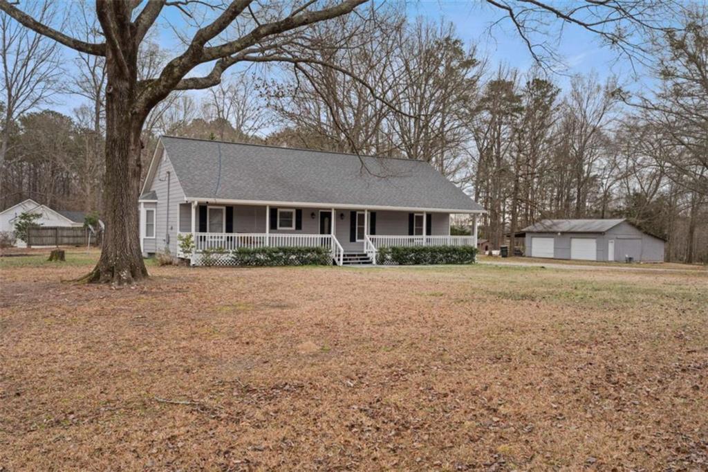 2284 Alcovy Station Road Covington, GA 30014 - Photo 3 of 45 a front view of a house with a yard and trees