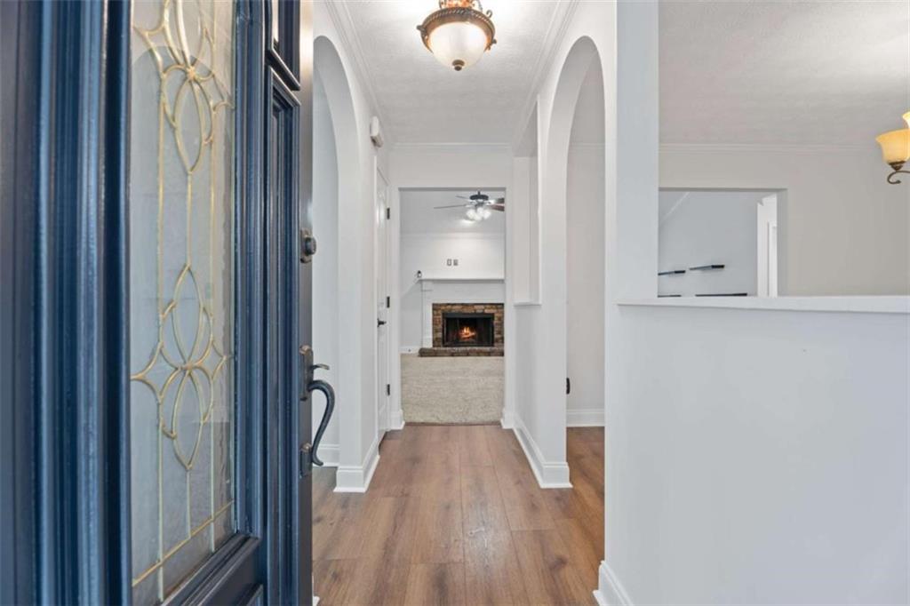 2284 Alcovy Station Road Covington, GA 30014 - Photo 9 of 45 a view of a hallway with wooden floor and staircase