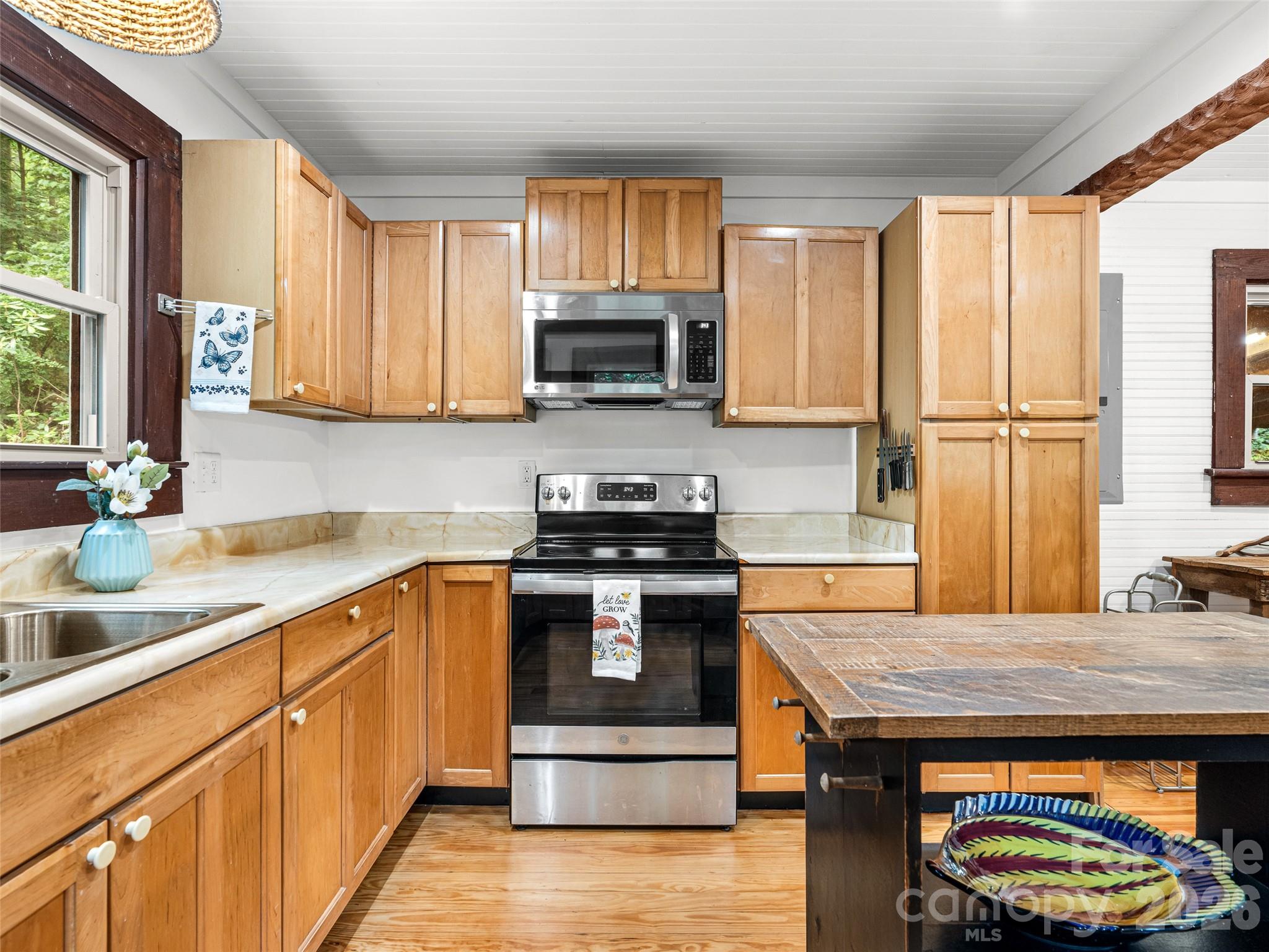 206 Chestnut Hill Road Gerton, NC 28735 - Photo 8 of 48 a kitchen with stainless steel appliances granite countertop a stove a sink and a microwave