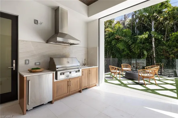 a kitchen with a stove and a view of living room