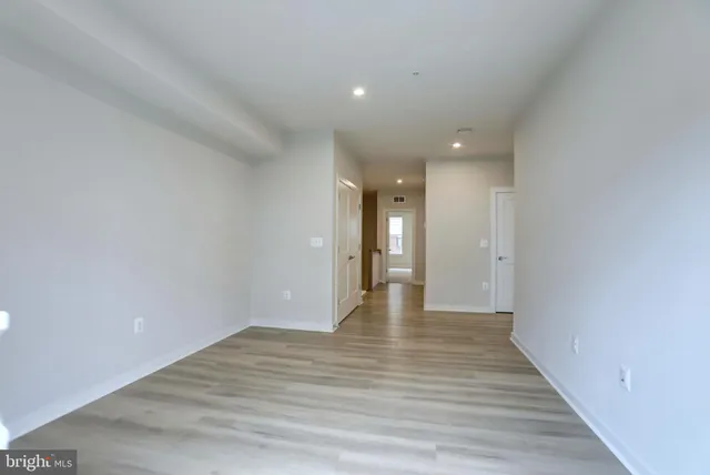 a view of an empty room and wooden floor