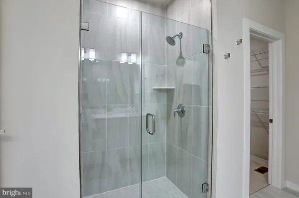 a bathroom with a glass shower door