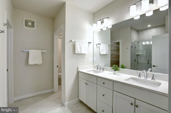 a bathroom with a double vanity sink and a mirror