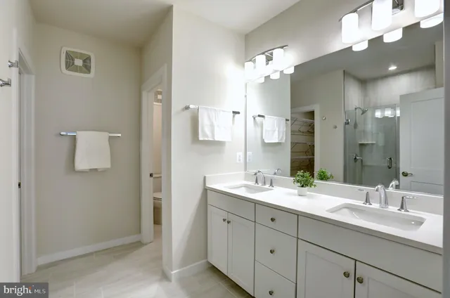 a bathroom with a double vanity sink and a mirror