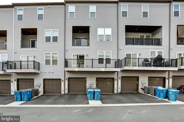 a front view of a brick house with many windows