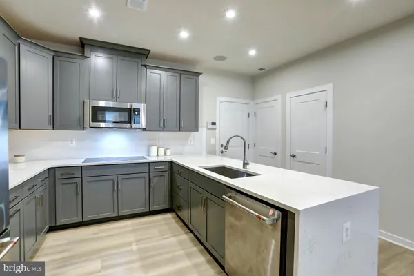 a kitchen with sink cabinets and microwave
